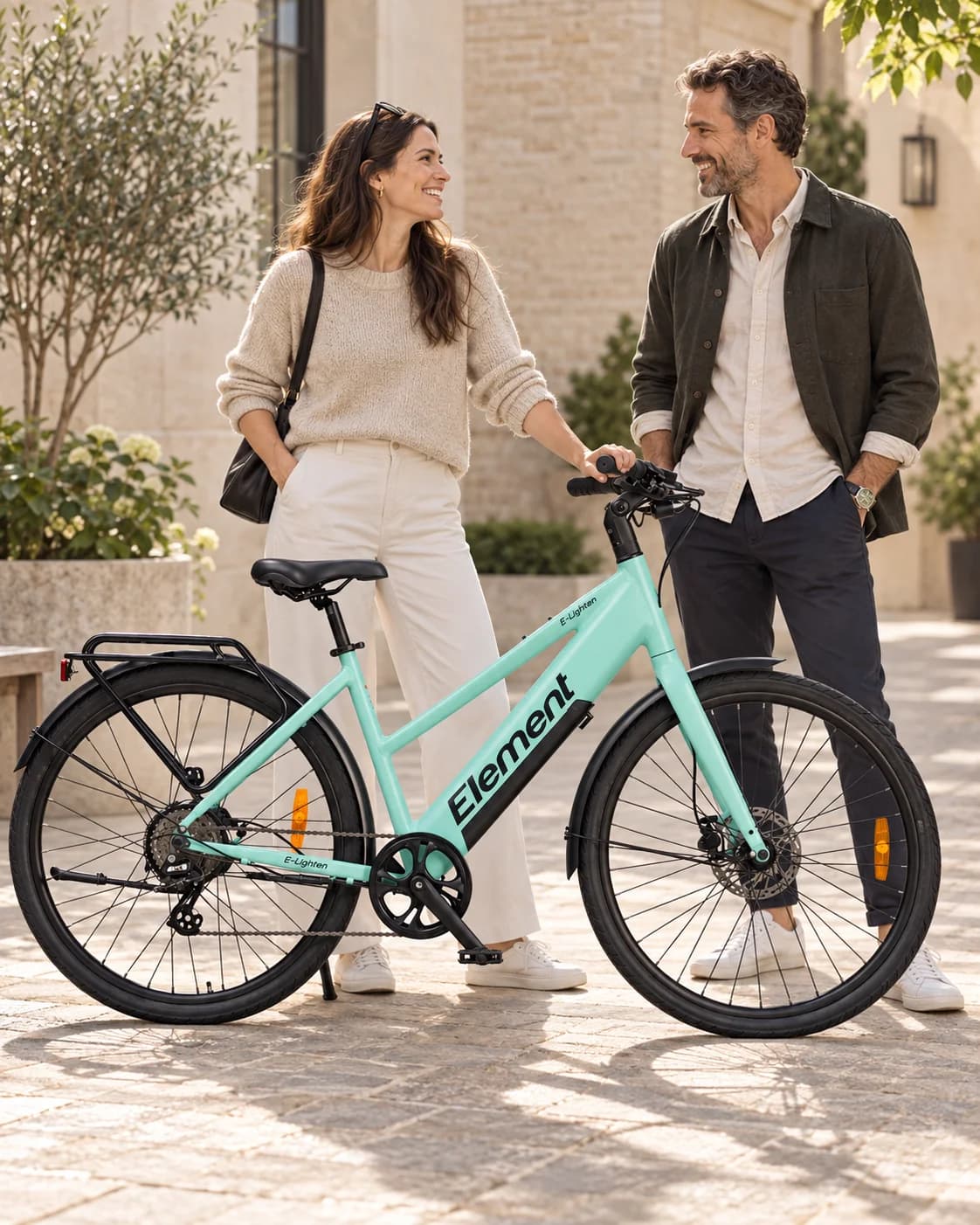 Two riders with a mint Element bike in a courtyard — illustrative AI campaign scene